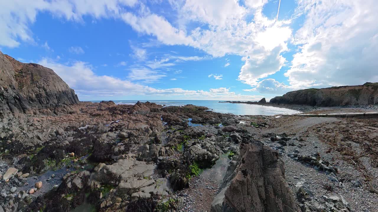 Ireland epic locations rising shot behind rocks low tide at Waterford beach