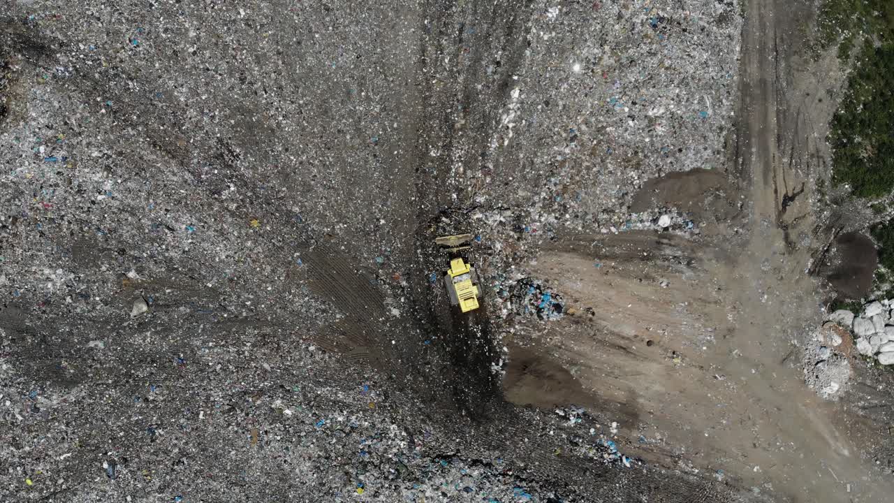 Aerial View of a Bulldozer Working in a Landfill