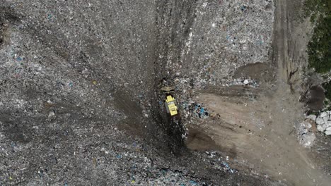 aerial view of a bulldozer working in a landfill