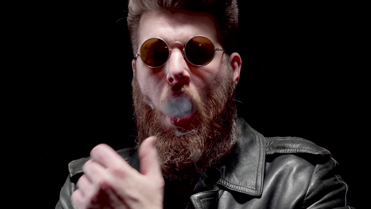 Man vaping with sunglasses and beard
