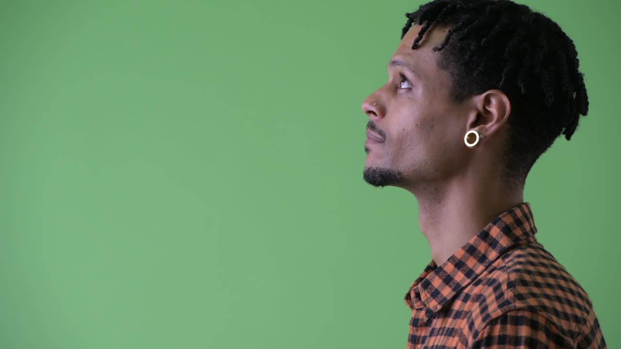 Happy young handsome African man with dreadlocks