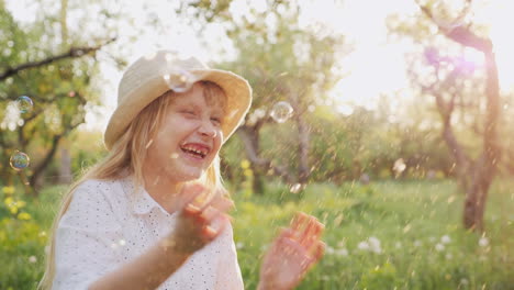 happy child playing with soap bubbles laughing