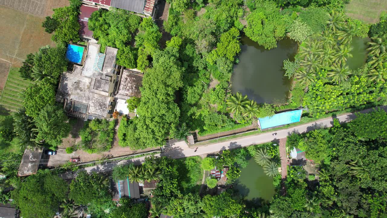 Satkhira coastal region rural village lush green vegetation, agricultural fields and small fishing ponds, Revealing drone shot