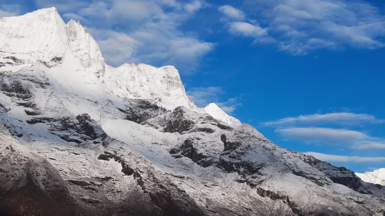 Snow-capped Himalayan peaks rise above the rugged trail to Everest Base Camp, offering trekkers stunning views as they journey through Nepal’s remote and scenic Khumbu region.