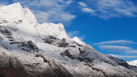 snow-capped himalayan peaks rise above the rugged trail to everest base camp, offering trekkers stunning views as they journey through nepal’s remote and scenic khumbu region.