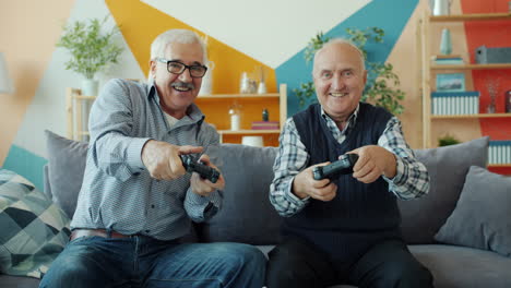 elderly men having fun playing video games together