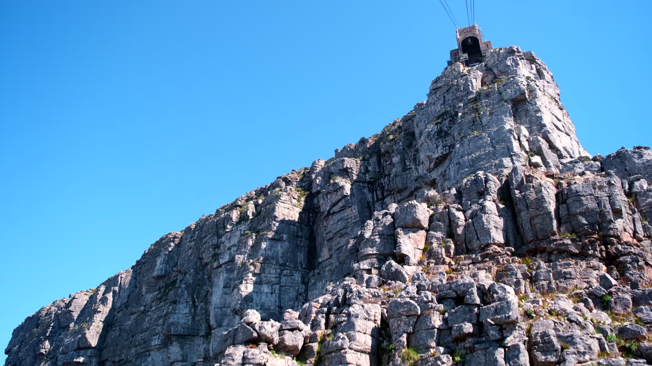 POV of cable car arriving at upper station of Table Mountain with craggy rocks
