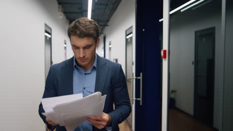 angry employee throwing documents in office hallway. irritated upset businessman