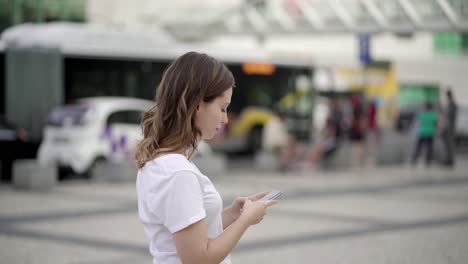 Side-view-of-attractive-young-lady-using-phone