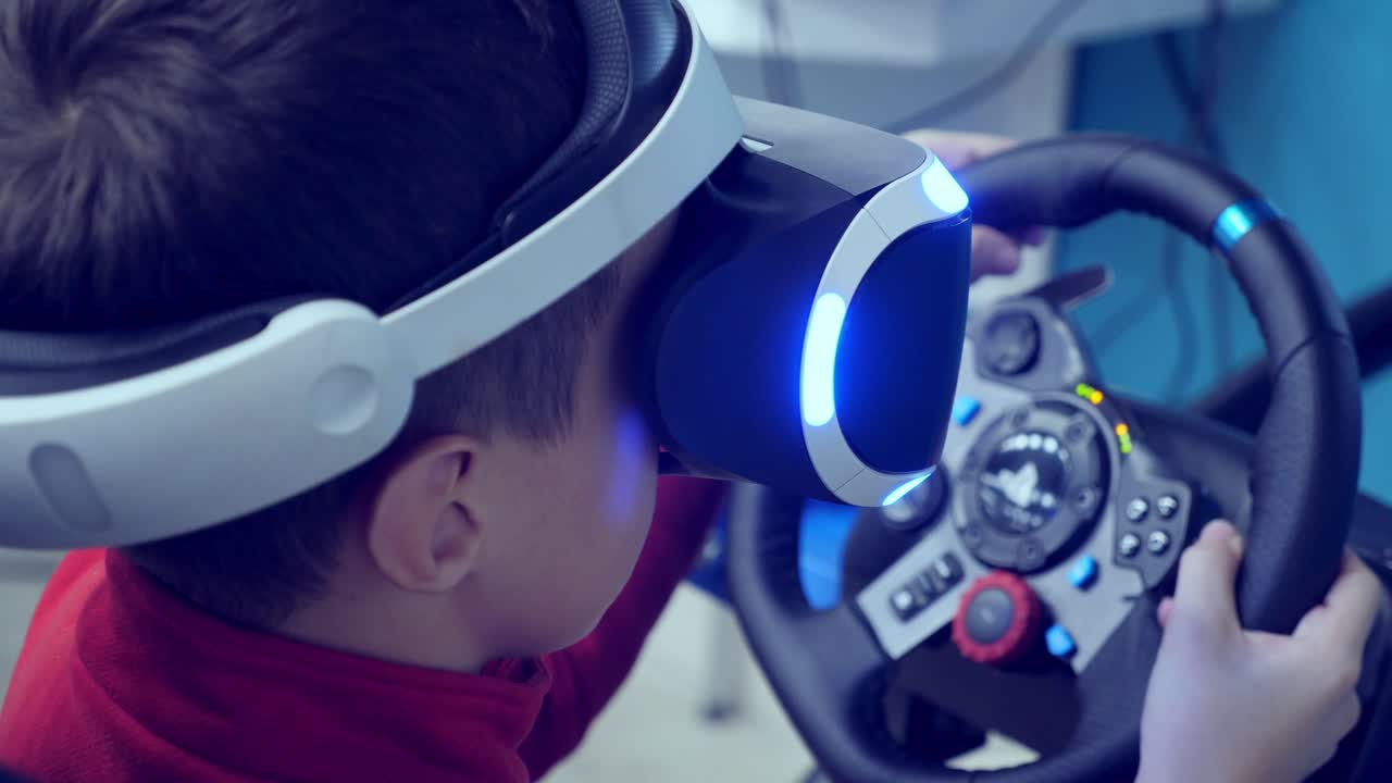 Boy playing a virtual reality racing game