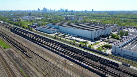 flying above industrial railroad station with cargo trains and freight containers