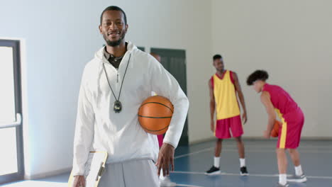 African-American-coach-poses-confidently-in-a-gym