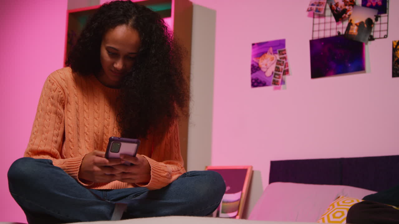 Teenage Girl Using Smartphone in Bedroom