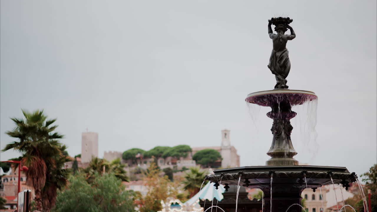 Water pouring in a fountain with a blurry background in Cannes, France