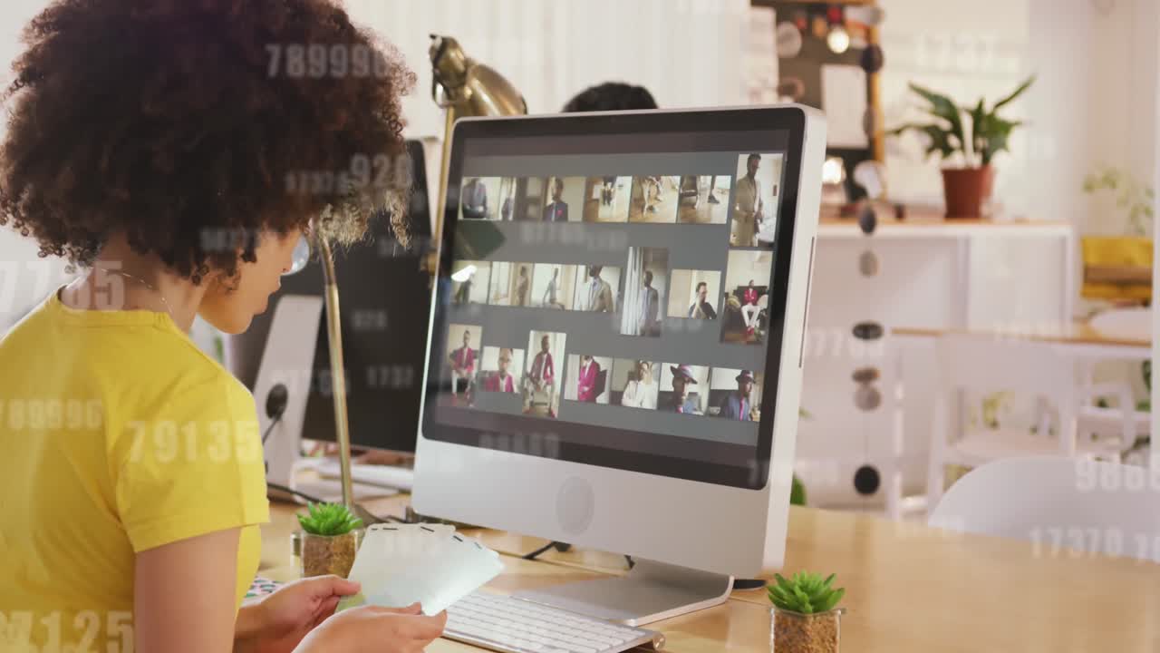 Animation of changing numbers over african american female graphic designer holding color swatches