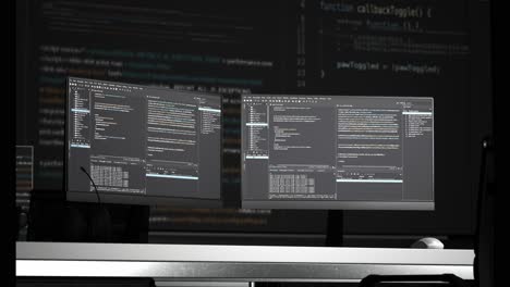 multiple computer screens displaying code