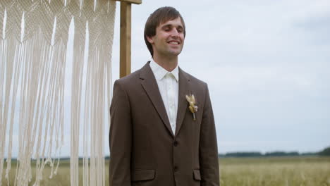 groom in an autumn field