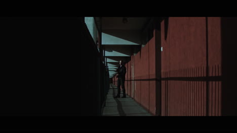 A bald gang member on guard