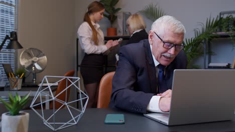 cunning senior businessman grandfather company director rubbing hands, waiting for money income