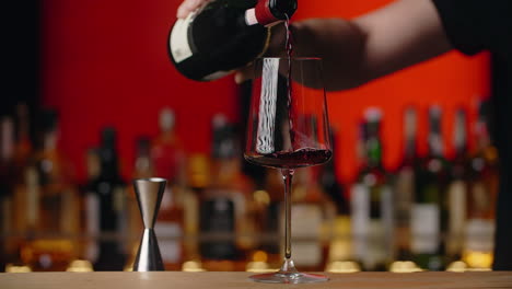 pouring red wine at a bar