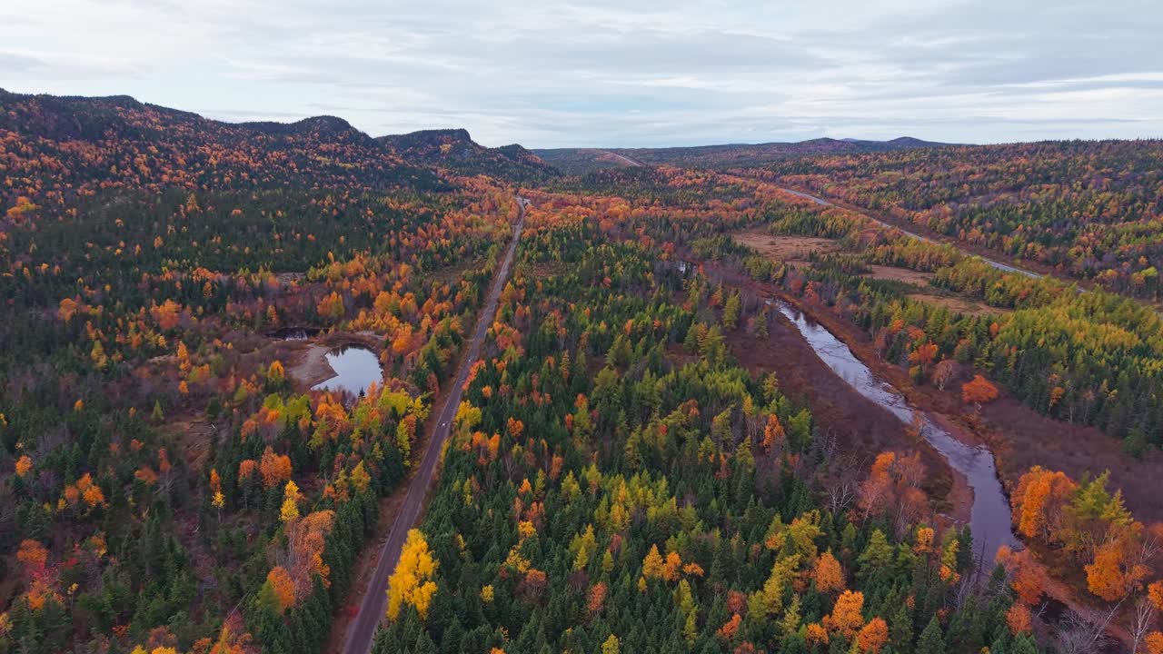 Drone footage shows remote village nestled among hills with misty hills