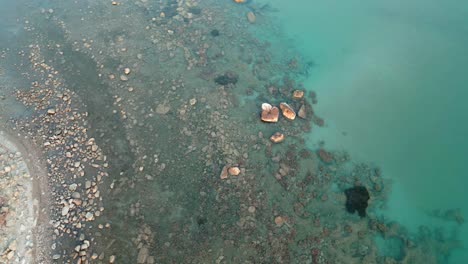 The-Adriatic-Sea,-coastline-on-a-pebble-beach,-visible-shallows-and-depths