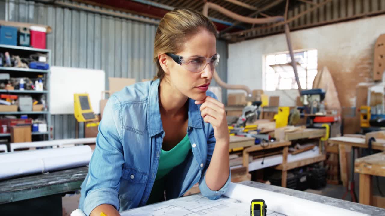 Attractive carpenter working on her plans