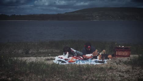 4k family having picnic next to the lake