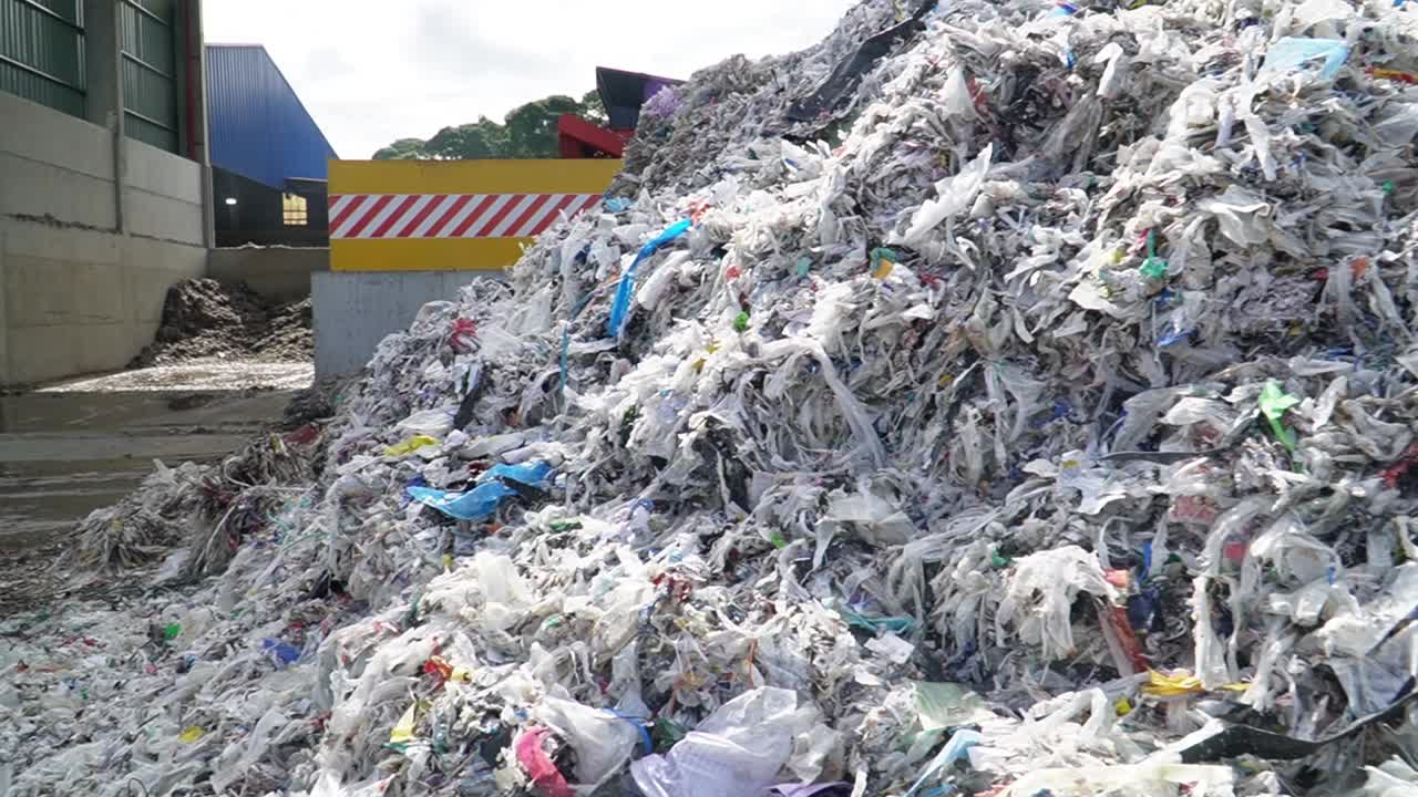 Explore the recycling process: drone captures the view of a massive scrap pile at the recycling factory