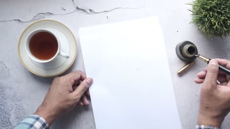 handwritten letter with tea and fountain pen