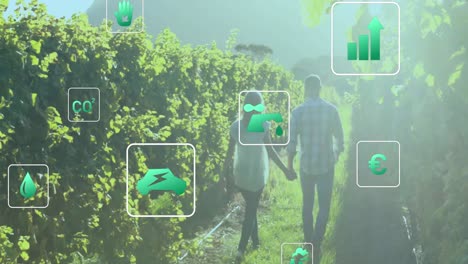 animación de iconos digitales de energía ecológica y verde sobre personas que se toman de la mano en el campo