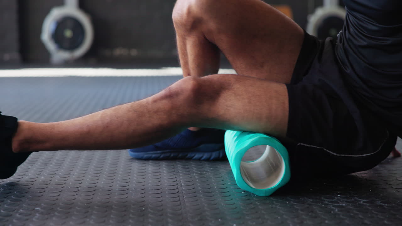Man foam rolling his leg