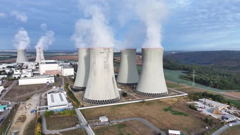 aerial landscape over dukovany nuclear power plant cooling towers emit vapor