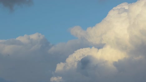 slow-moving fluffy clouds on a blue sky