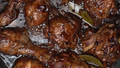 top-down-view-of-braising-chicken-legs-and-chicken-thighs-in-dark-glaze-sauce