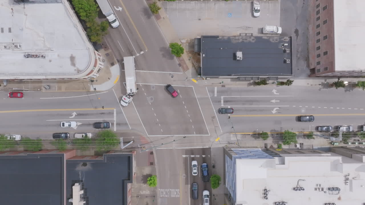 An overhead aerial shot of a uniquely shaped downtown Chattanooga intersection shows multiple traffic patterns and surrounding mid-rise buildings along Market Street