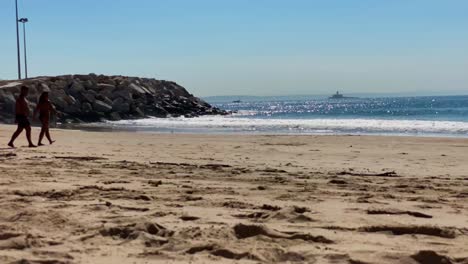 Group-of-people-having-fun-at-Torre-beach-near-Marine-in-Cascais,-Portugal