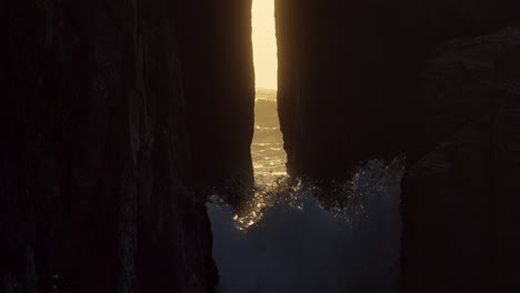 low peaceful waves lap through the rock walls of song of the sea cave