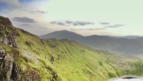 dramatic aerial as the camera follows the mountain ridges along mount snowden in snowdonia national park - wilderness and survival concepts