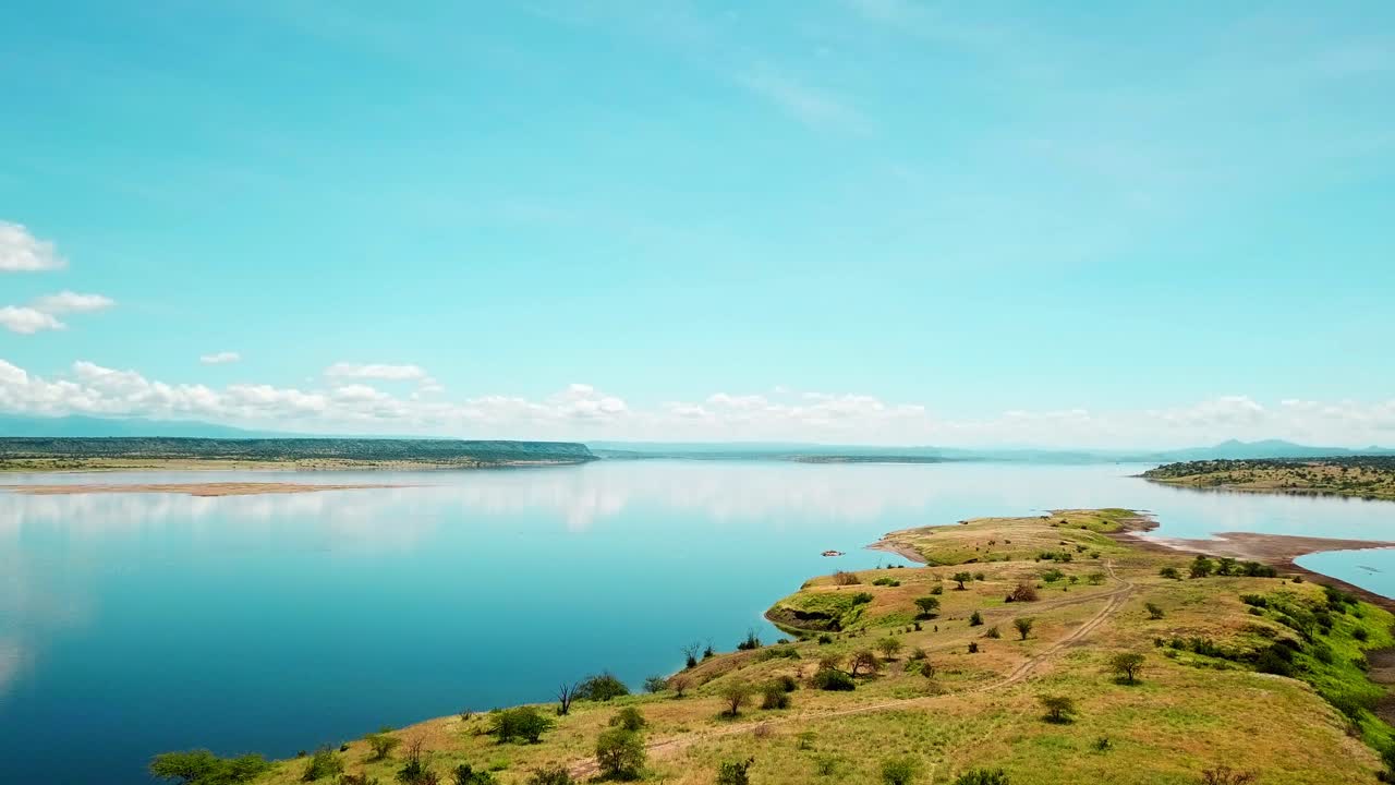hombre masai sentado con vistas al paisaje del lago magadi en kenia - toma aérea de drones