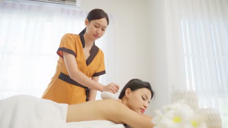 woman receiving a back massage at a spa