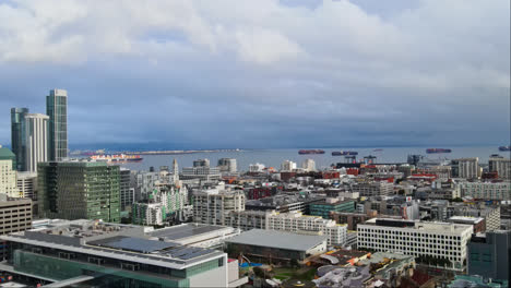 Panoramic-aerial-of-San-Francisco-skyline-buildings,-South-Beach-Harbour-Bay-ferry-pier-and-ships-in-the-background,-CA,-USA