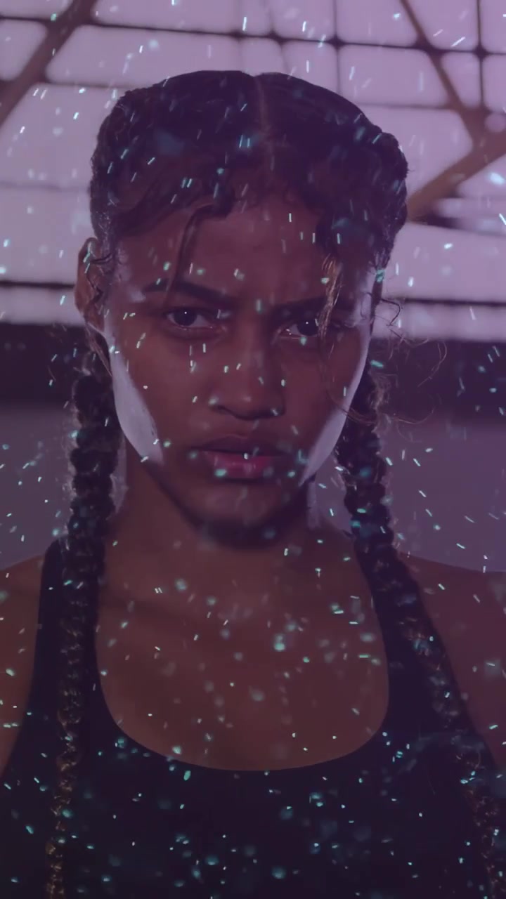 Vertical video: Projection starting, woman holding lowering arms, bathing teal dots for fitness