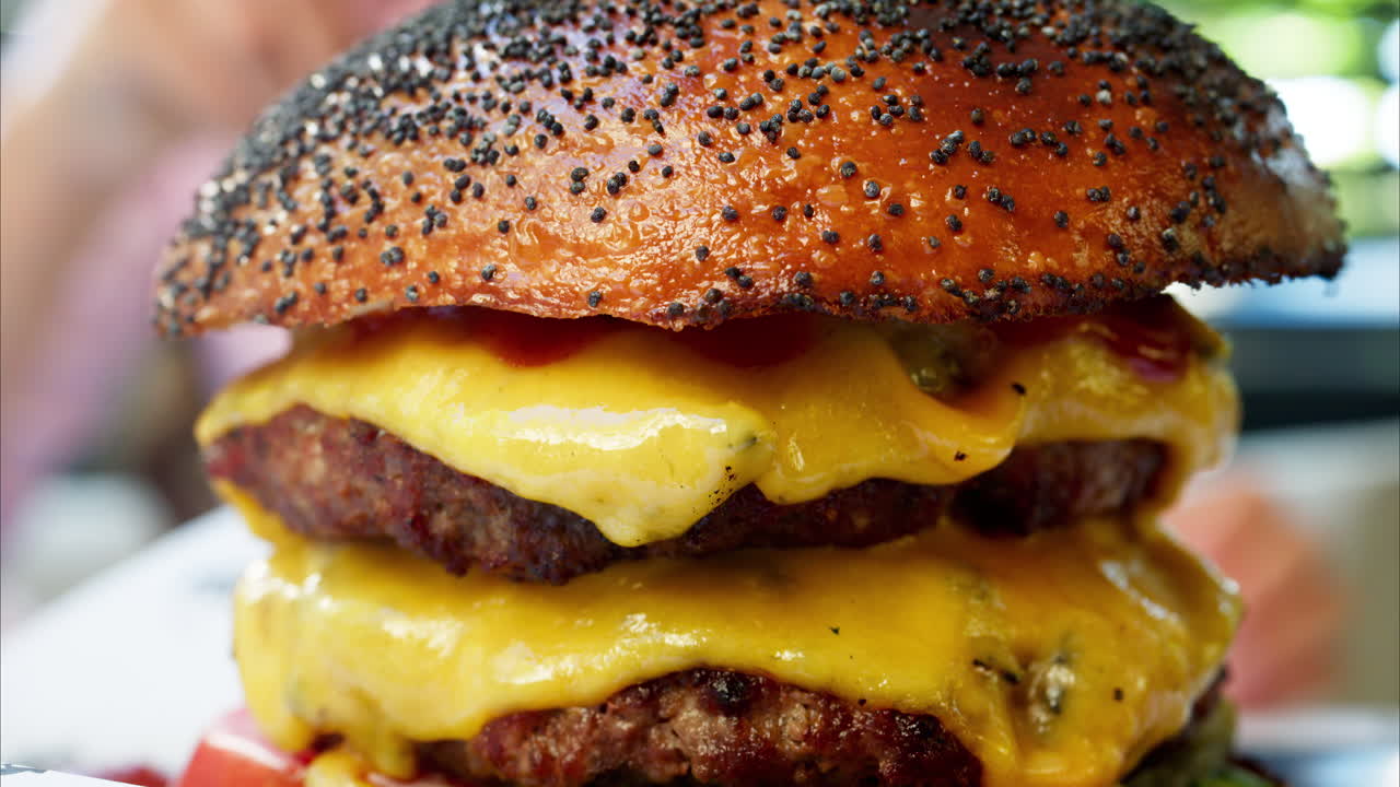 Close up of a big hamburger on a table at a restaurant