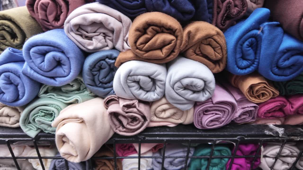 Close-Up of Stacked Colorful Rolled Fabrics in a Shop