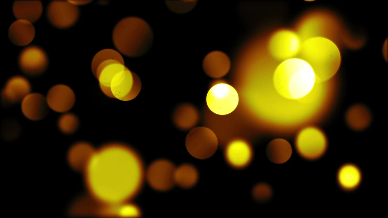 Abstraktit kultaiset bokeh-valot liikkuvat tummalla taustalla