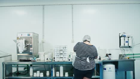 lady working and sorting food for a family owned business in a factory