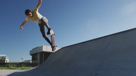 Caucasian-man-riding-and-jumping-on-skateboard-on-sunny-day