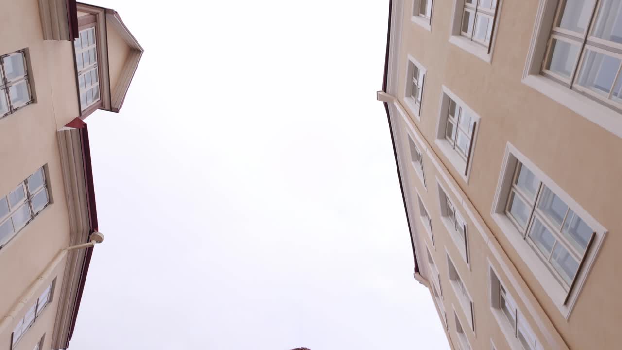 Tourists Walking On Cobblestone Streets At Tallinn Old Town In Estonia. tilt-down, wide shot