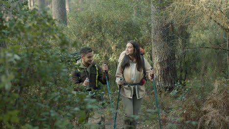 young couple walking up narrow tourist trail